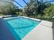 A screened-in pool with clear, blue water with an attached spa at 7480 Aguila Dr, Sarasota, FL 34240