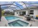 Backyard screened-in pool with connected hot tub, patio area and seating at 7480 Aguila Dr, Sarasota, FL 34240