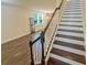 Elegant staircase leads to an open living area with hardwood floors and natural light at 7480 Aguila Dr, Sarasota, FL 34240