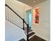 Elegant staircase featuring dark wood treads and white risers at 7480 Aguila Dr, Sarasota, FL 34240