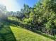 Green grass and mature landscaping surrounding the home at 7480 Aguila Dr, Sarasota, FL 34240
