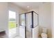 Bathroom featuring a modern glass-enclosed shower, toilet and vanity with a view to the outside at 14036 Prairie Hill Rd, Dade City, FL 33525