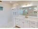 Elegant bathroom featuring a glass shower, and a luxurious vanity with gold fixtures at 14036 Prairie Hill Rd, Dade City, FL 33525