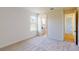 Comfortable bedroom with plush carpeting and lots of natural light, adjacent to the bathroom at 14036 Prairie Hill Rd, Dade City, FL 33525