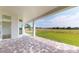Covered patio showcasing beautiful views of the backyard and an open-air design at 14036 Prairie Hill Rd, Dade City, FL 33525