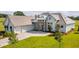 Attractive exterior view with a three car garage, manicured lawn, and stone facade at 14036 Prairie Hill Rd, Dade City, FL 33525