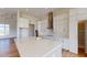 Modern kitchen features white cabinets, a center island, and stainless steel appliances at 14036 Prairie Hill Rd, Dade City, FL 33525