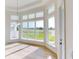 Bright and airy living room with hardwood floors and expansive windows overlooking a lush landscape at 14036 Prairie Hill Rd, Dade City, FL 33525