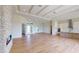 Open concept living area features a fireplace, wood floors, and access to kitchen and exterior at 14036 Prairie Hill Rd, Dade City, FL 33525