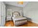 Comfortable bedroom with a wooden bed frame and decorative pillows, complemented by natural light from the windows at 505 Sally Lee Dr, Ellenton, FL 34222