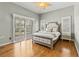 Bright bedroom with shuttered windows, hardwood flooring and neutral color scheme at 505 Sally Lee Dr, Ellenton, FL 34222