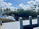 Close-up view of the boat next to the dock featuring a Baja boat parked at the end of the dock at 505 Sally Lee Dr, Ellenton, FL 34222
