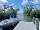 Boat on the dock with palm trees, water access, and beautiful blue skies in the background at 505 Sally Lee Dr, Ellenton, FL 34222