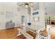 Dining space with high ceilings, wooden table, bench seating and view to kitchen at 505 Sally Lee Dr, Ellenton, FL 34222
