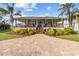 Charming home with a large front porch, well-manicured landscaping, and brick driveway, exuding curb appeal at 505 Sally Lee Dr, Ellenton, FL 34222