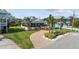 Attractive home showcasing a large front porch, brick driveway, and verdant landscaping, adding to its charm at 505 Sally Lee Dr, Ellenton, FL 34222