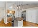 Kitchen with island, stainless steel refrigerator and view to dining room at 505 Sally Lee Dr, Ellenton, FL 34222