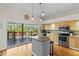 Bright kitchen with island, stainless steel appliances, and sliding doors to deck at 505 Sally Lee Dr, Ellenton, FL 34222