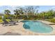 Private backyard pool featuring a sun deck, lounge chairs, and tropical landscaping, perfect for relaxation at 505 Sally Lee Dr, Ellenton, FL 34222