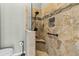 Tiled shower with built-in seat, showerhead, and grab bar combining style and accessibility at 505 Sally Lee Dr, Ellenton, FL 34222