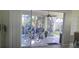 Enclosed lanai with tiled flooring, sliding glass doors, and a view of the backyard at 1287 Lakeside Woods Dr, Venice, FL 34285