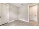 Neutral-toned bedroom with tiled floor, white trim and doors at 14370 Hammock Oak St, Parrish, FL 34219