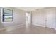 This bedroom features a tray ceiling, tile flooring, and an exterior view window for ample natural light at 14370 Hammock Oak St, Parrish, FL 34219