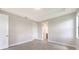 This bedroom features a tray ceiling, tile flooring, and two paneled doors to other rooms in the home at 14370 Hammock Oak St, Parrish, FL 34219