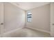 Cozy bedroom featuring neutral walls, white trim, tile floors and window at 14370 Hammock Oak St, Parrish, FL 34219