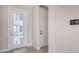 A foyer with a decorative glass front door and tile flooring, leading into the home at 14370 Hammock Oak St, Parrish, FL 34219