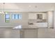 Beautiful kitchen with a large island featuring a granite countertop, stainless steel appliances and tile flooring at 14370 Hammock Oak St, Parrish, FL 34219