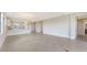 Open-concept living room showcases neutral tile flooring and access to kitchen at 14370 Hammock Oak St, Parrish, FL 34219