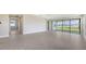 Open living room featuring light tile floor, recessed lighting and large sliding glass doors at 14370 Hammock Oak St, Parrish, FL 34219