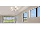 Bright living room with recessed lighting, large windows, and view of the outside yard at 14370 Hammock Oak St, Parrish, FL 34219