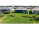 Aerial view of the backyard featuring a lush lawn with newly planted trees and a covered lanai at 4621 Mondrian Ct, Sarasota, FL 34240