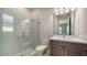 Bathroom featuring a glass-enclosed shower, white marble-like tiling and a vanity with modern fixtures at 4621 Mondrian Ct, Sarasota, FL 34240