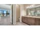 Primary bathroom featuring double sink vanity, a glass shower, and tile flooring at 4621 Mondrian Ct, Sarasota, FL 34240