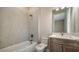 Bathroom featuring a shower and tub combination with white marble-like tiling and a vanity with modern fixtures at 4621 Mondrian Ct, Sarasota, FL 34240