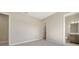 Spacious bedroom featuring neutral walls, carpet, and a doorway leading to the bathroom at 4621 Mondrian Ct, Sarasota, FL 34240