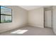Neutral bedroom featuring carpet flooring, a window for natural light, and a closet for ample storage space at 4621 Mondrian Ct, Sarasota, FL 34240