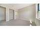Neutral bedroom with carpet, a large window, and a closet, offering ample storage at 4621 Mondrian Ct, Sarasota, FL 34240