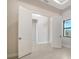 Bedroom with double doors, neutral paint, tiled floor and a view of the outside through an adjacent window at 4621 Mondrian Ct, Sarasota, FL 34240
