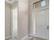 Bright entryway featuring a white front door with sidelight and transom window, leading into the home at 4621 Mondrian Ct, Sarasota, FL 34240