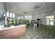 Community gym with many machines, large windows, ceiling fans, and geometric carpet at 4621 Mondrian Ct, Sarasota, FL 34240