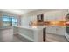 A kitchen has a gas range, stainless steel appliances, white cabinets, and a center island with a sink at 4621 Mondrian Ct, Sarasota, FL 34240