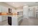 Modern kitchen with white cabinets, large island, brick backsplash, and stainless steel appliances at 4621 Mondrian Ct, Sarasota, FL 34240