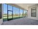 Screened-in lanai with brick flooring overlooking the backyard and neighborhood with a water view at 4621 Mondrian Ct, Sarasota, FL 34240