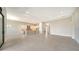 Spacious living room and kitchen area featuring an island, white cabinets, recessed lighting, and tile flooring throughout at 4621 Mondrian Ct, Sarasota, FL 34240