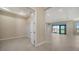 Expansive living room with neutral tile flooring, recessed lighting, and sliding glass doors to the lanai at 4621 Mondrian Ct, Sarasota, FL 34240