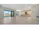 Bright, open living space with tiled floors, modern kitchen, and sliding glass doors leading to outdoor area at 4621 Mondrian Ct, Sarasota, FL 34240